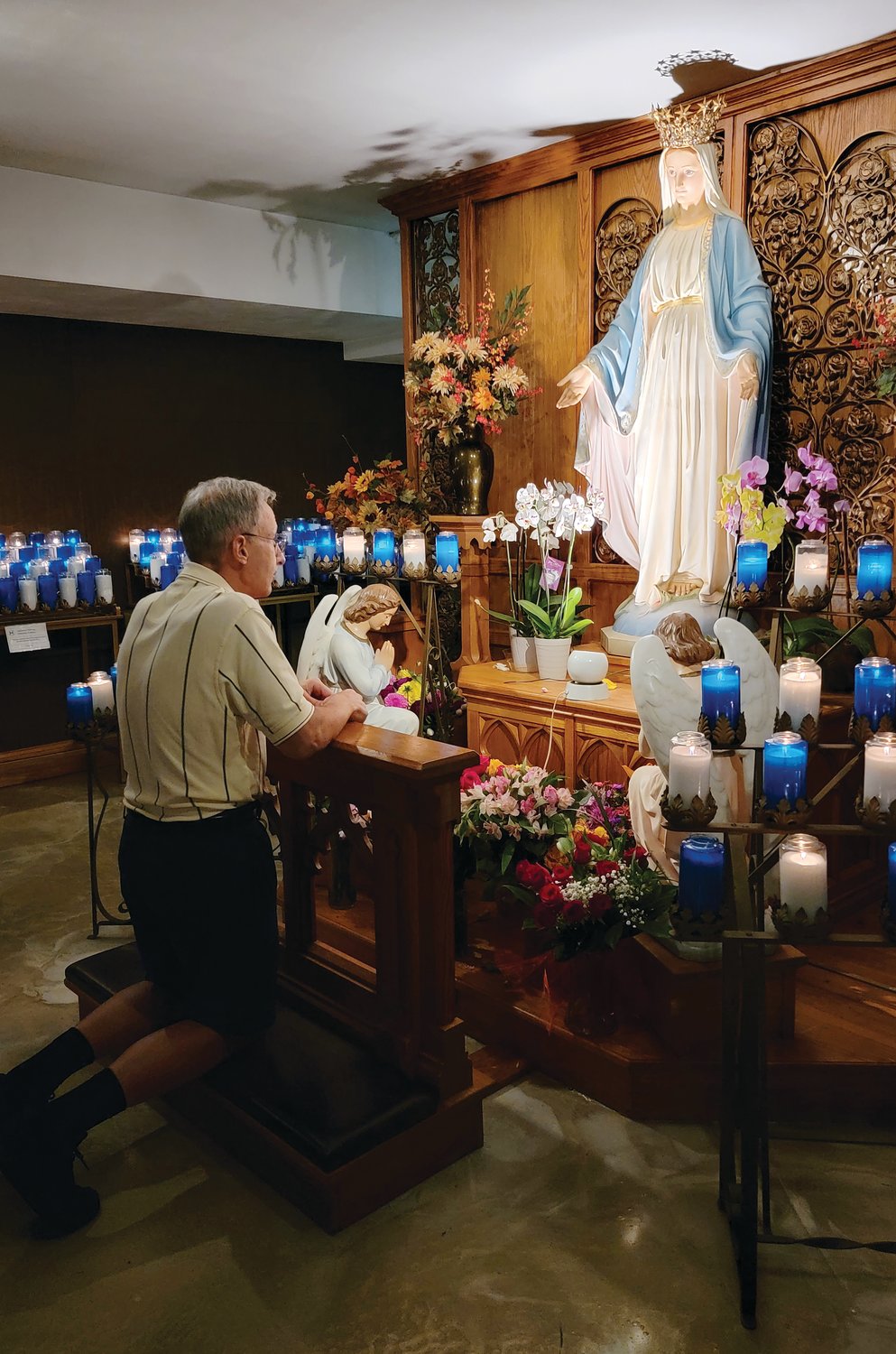 Father Suriani takes a moment to pray in front of the Blessed Mother at the National Shrine of Our Lady of Good Help, a Marian shrine, located within the Roman Catholic Diocese of Green Bay.